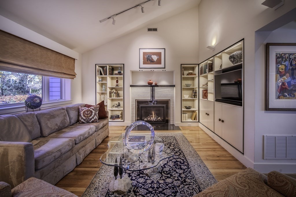 37 Beverly Road Arlington, MA 02474 - Photo 6 of 42 a living room with furniture flat screen tv and a fireplace
