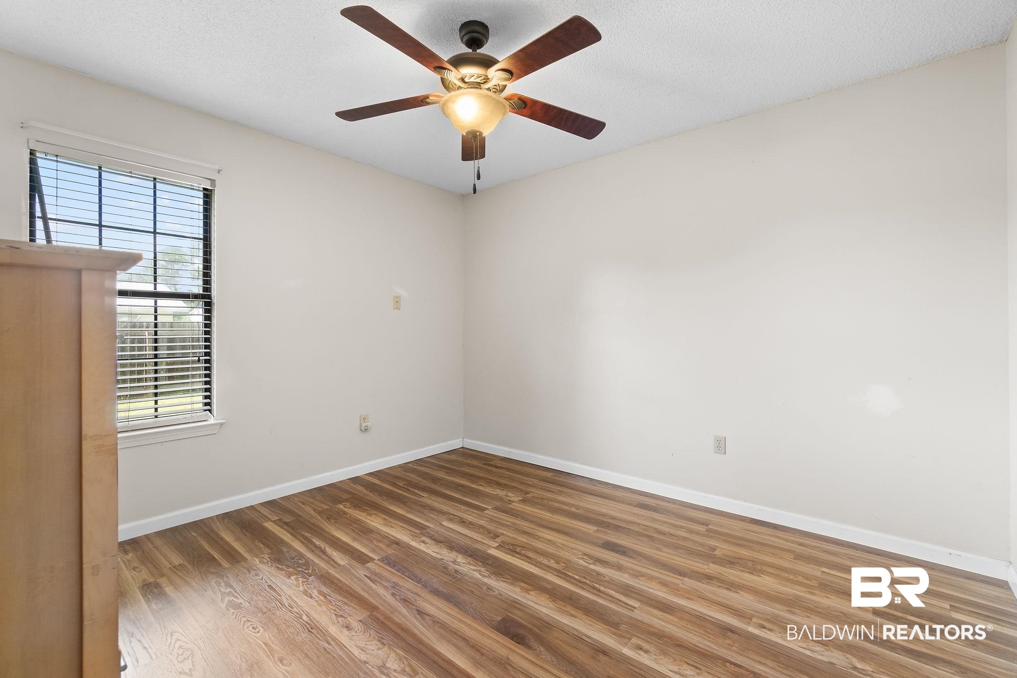 33135 Collier Road Lillian, AL 36549 - Photo 20 of 30 Spare room with wood finished floors, ceiling fan, and a textured ceiling