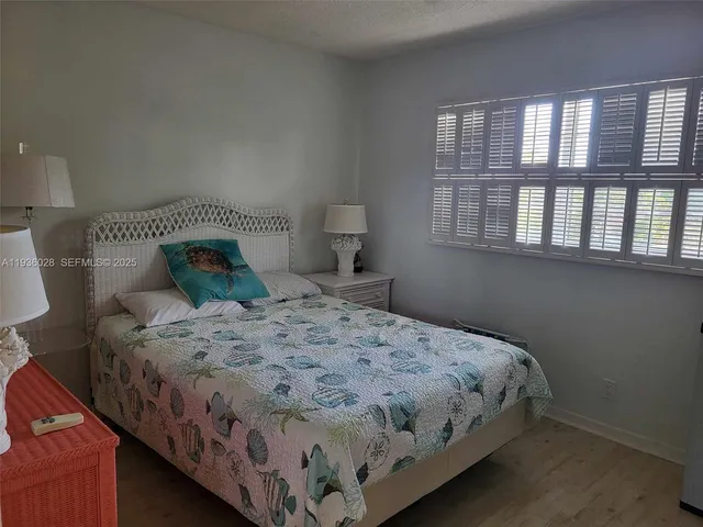 a bedroom with a bed next to a window