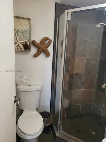 a white toilet sitting next to a bathroom sink
