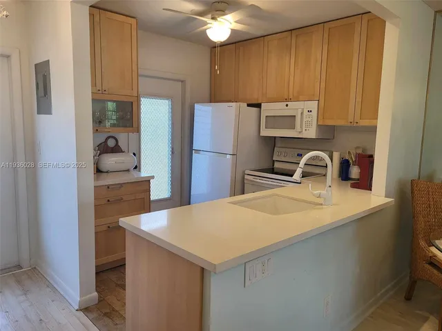 a kitchen with a sink a stove and refrigerator