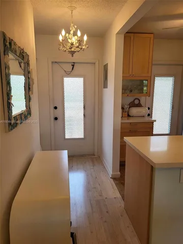 a kitchen that has a lot of cabinets and stainless steel appliances