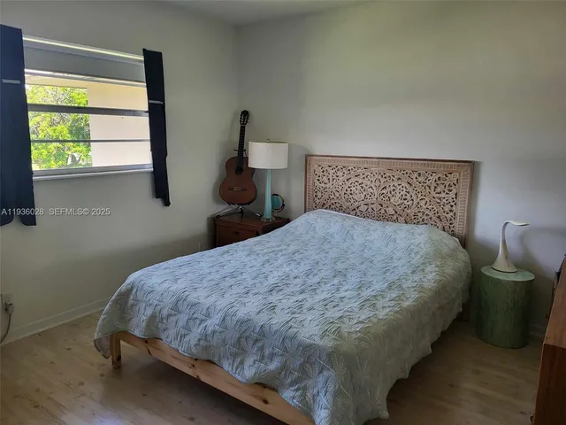 a bed sitting in a bedroom next to a window
