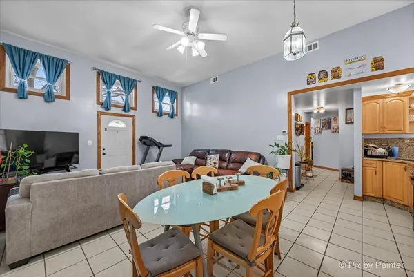 a kitchen with a dining table and chairs