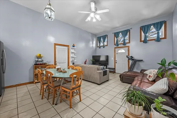 a living room with furniture and a baby crib