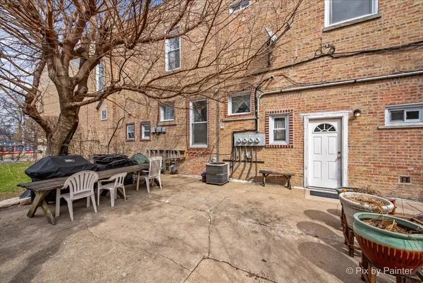 a kitchen with stainless steel appliances granite countertop a kitchen island a table and chairs