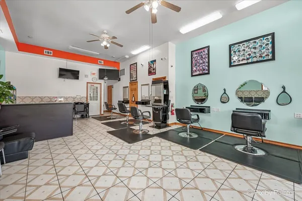 a living room with stainless steel appliances granite countertop furniture and a chandelier