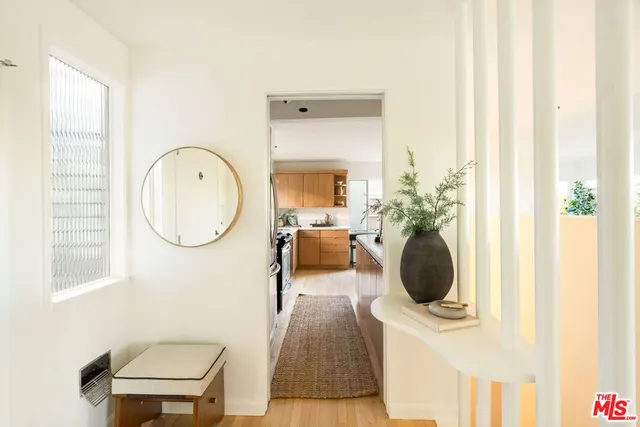a living room with furniture a window and a wooden floor
