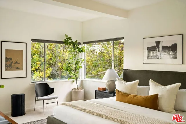 a bedroom with a large bed and a window