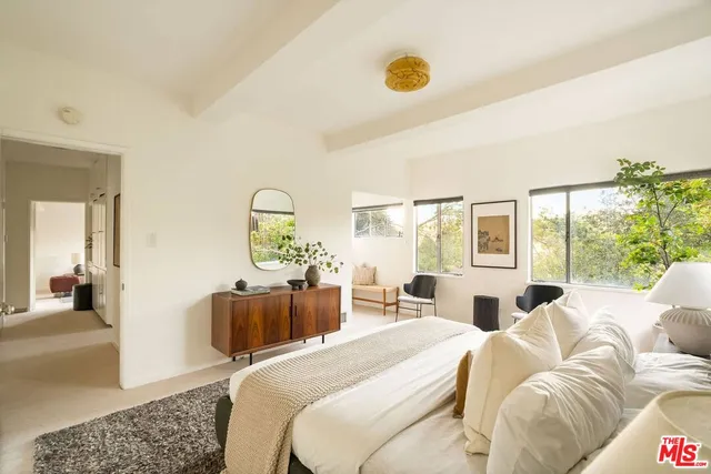 a bedroom with a bed couch and window