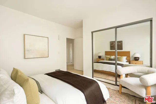 a bedroom with a bed and lamp