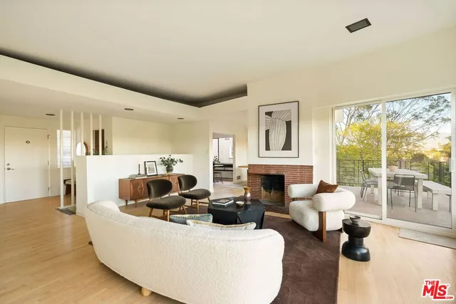 a living room with furniture fireplace and flat screen tv
