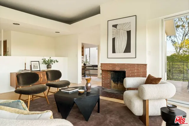 a living room with furniture or couch and a potted plant