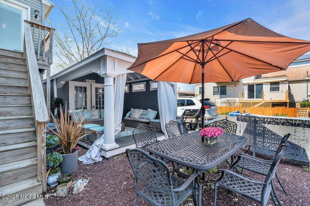 19 Gravelly Point Road Highlands, NJ 07732 - Photo 23 of 35 a view of a patio with table and chairs under an umbrella
