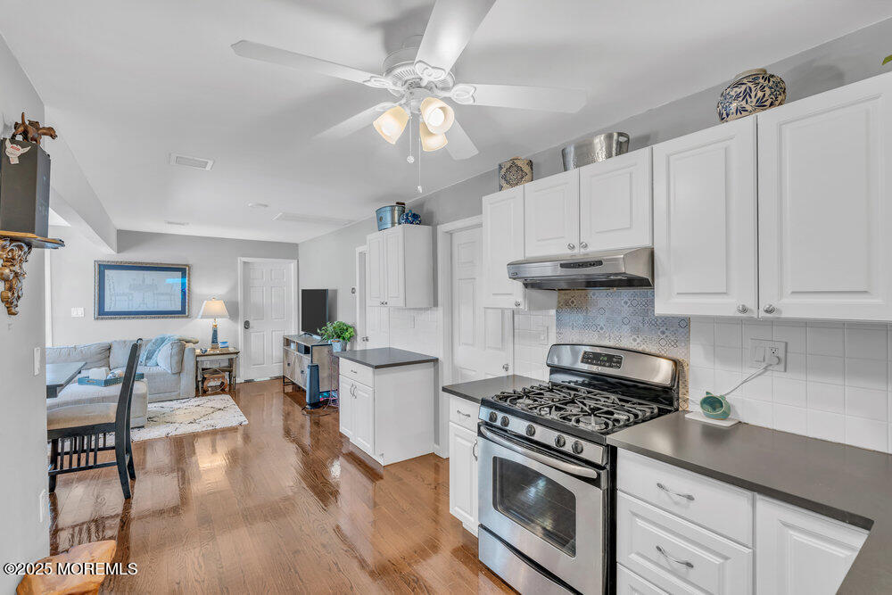 19 Gravelly Point Road Highlands, NJ 07732 - Photo 4 of 35 a kitchen with stainless steel appliances a white stove cabinets and wooden floor
