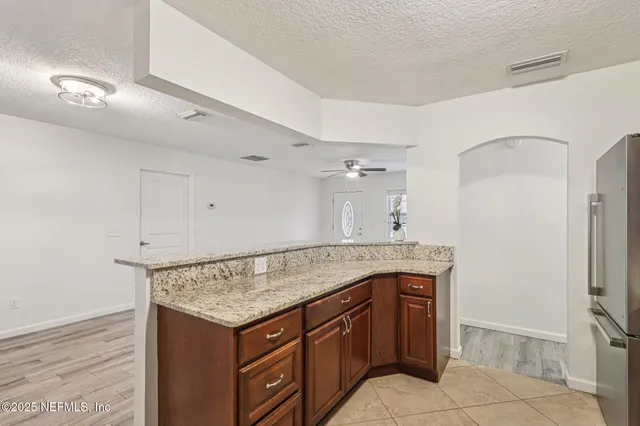 a kitchen with stainless steel appliances granite countertop a stove and a sink