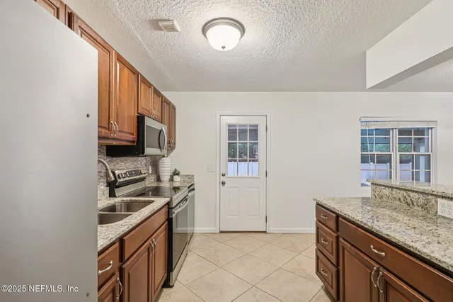 a kitchen that has a sink and a stove