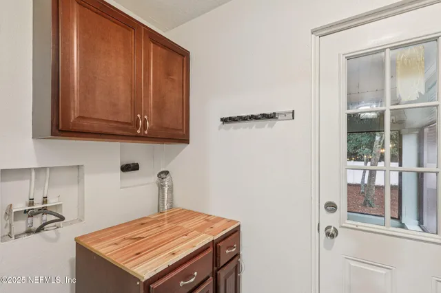 a kitchen with a sink refrigerator and cabinets