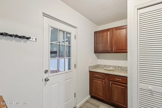 a kitchen with a refrigerator and cabinets