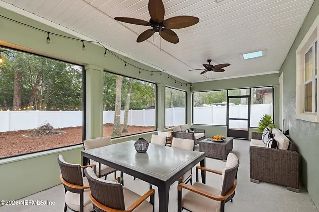 a dining room with furniture a chandelier and window