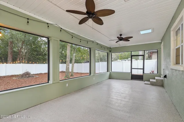 a view of room with window and ceiling fan