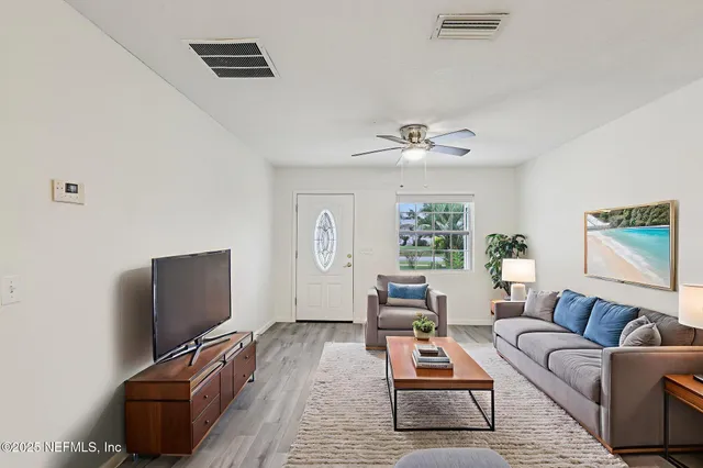 a living room with furniture rug and window