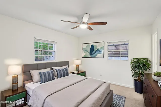 a bedroom with a large bed and a window