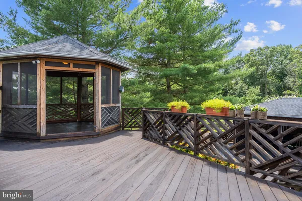 a view of a patio with table and chairs and wooden floor