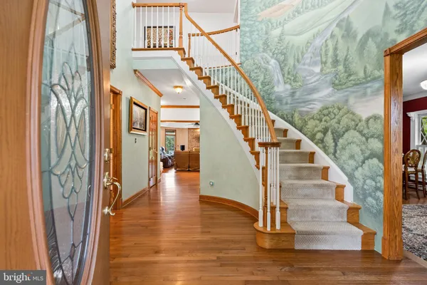 a view of entryway and hall with wooden floor