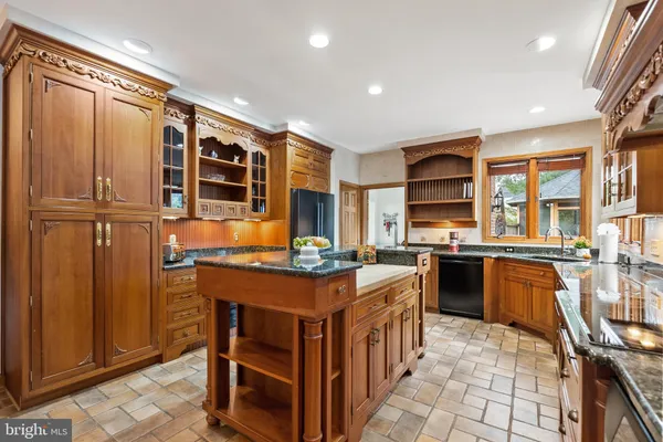 a kitchen with stainless steel appliances a stove top oven and cabinets