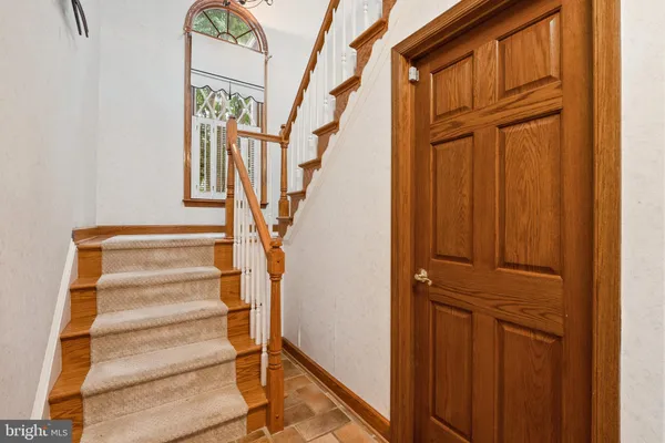 a bedroom with bed a flat tv screen and a dresser