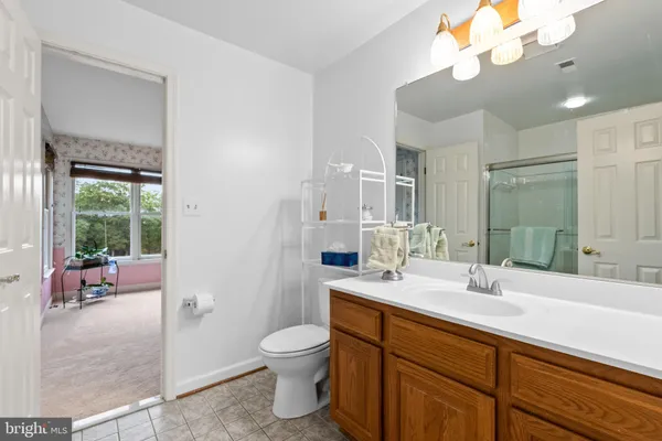 a bed sitting in a room next to a window