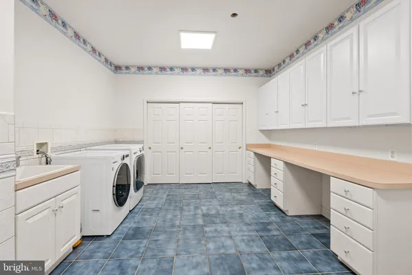 an aerial view of ocean with residential houses with outdoor space and trees all around