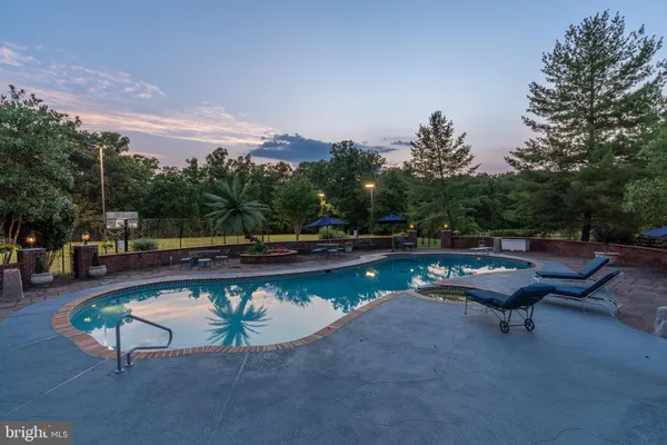 a swimming pool with outdoor seating and yard