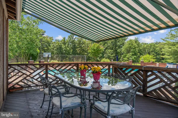 a view of balcony with wooden floor and seating space