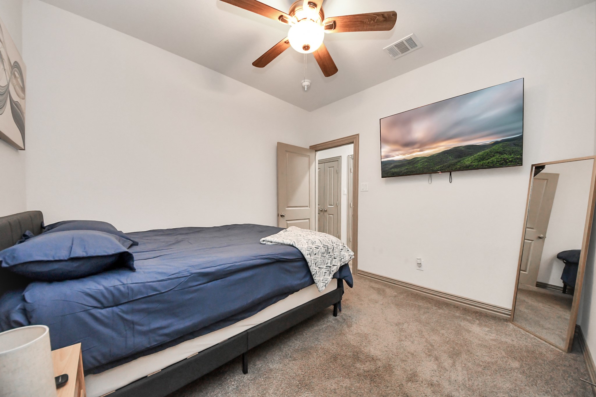 5334 Pershing Street Houston, TX 77033 - Photo 19 of 43 a bedroom with a bed and a flat screen tv