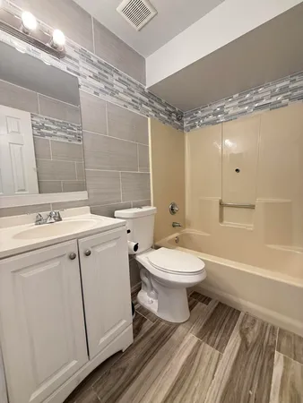 a bathroom with a toilet sink and shower