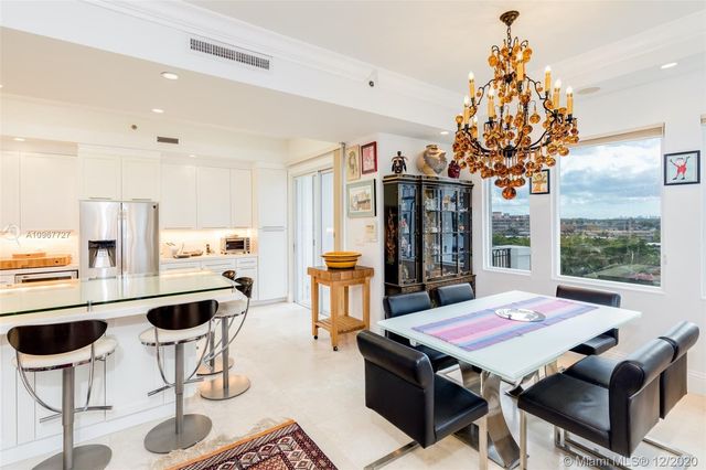 a living room with furniture a chandelier and a table