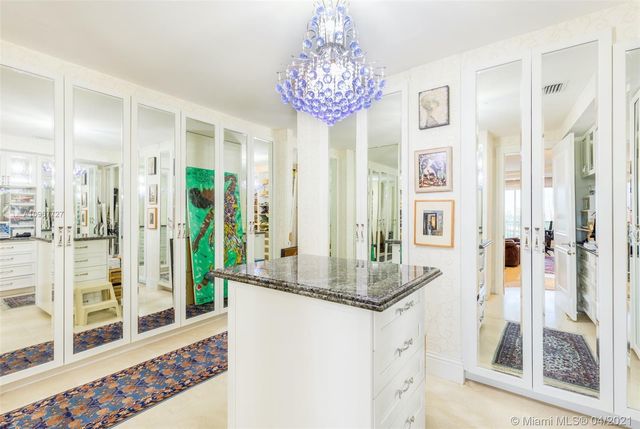 a bathroom with a granite countertop shower a mirror and a sink