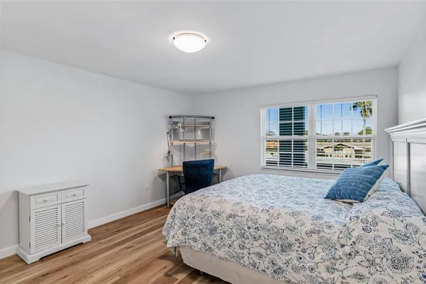 a bedroom with a bed and window