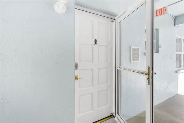 a hallway with a view of living room