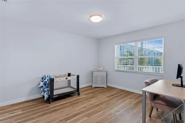 a view of a room with wooden floor a sink and a window