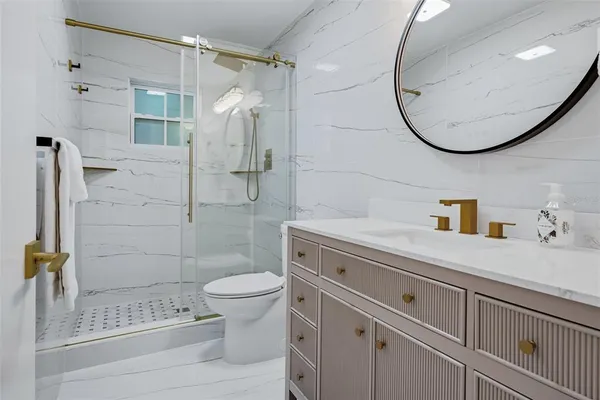 a view of a swimming pool with outdoor seating and plants