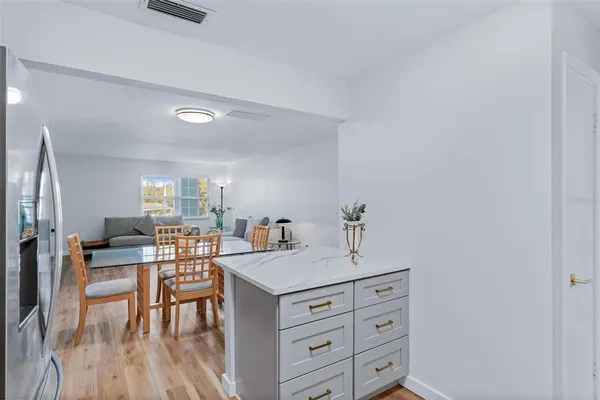 a kitchen with stainless steel appliances a sink stove refrigerator and cabinets