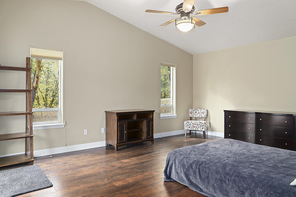 520 Stewart Road Grants Pass, OR 97526 - Photo 14 of 47 a bedroom with a bed and a fireplace