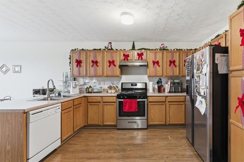 809 Winsap Drive Stockbridge, GA 30281 - Photo 13 of 41 a kitchen with stainless steel appliances granite countertop a refrigerator and a sink