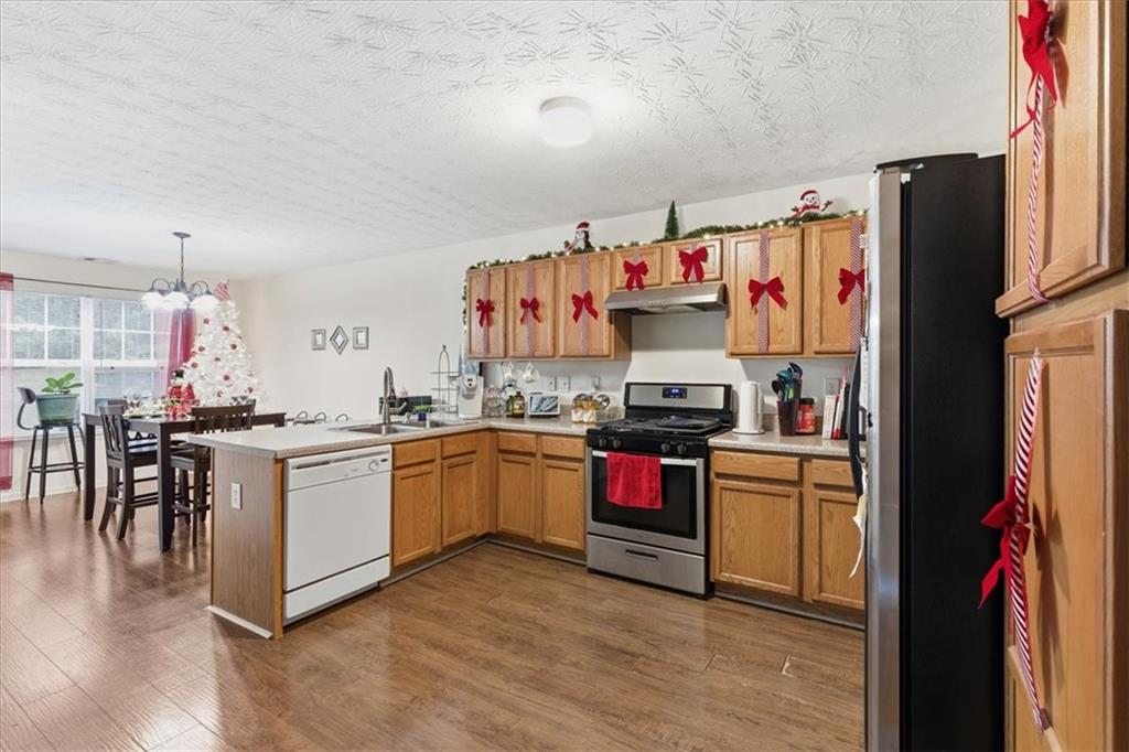809 Winsap Drive Stockbridge, GA 30281 - Photo 14 of 41 a kitchen with granite countertop a refrigerator and a stove top oven