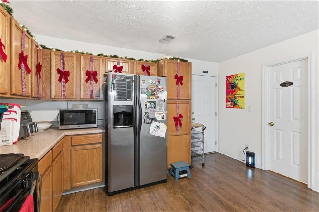 809 Winsap Drive Stockbridge, GA 30281 - Photo 16 of 41 a kitchen with stainless steel appliances a refrigerator and a sink