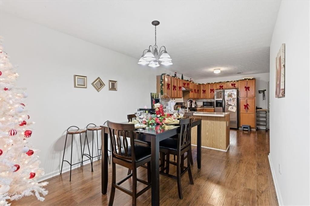 809 Winsap Drive Stockbridge, GA 30281 - Photo 18 of 41 a view of a dining room with furniture and wooden floor
