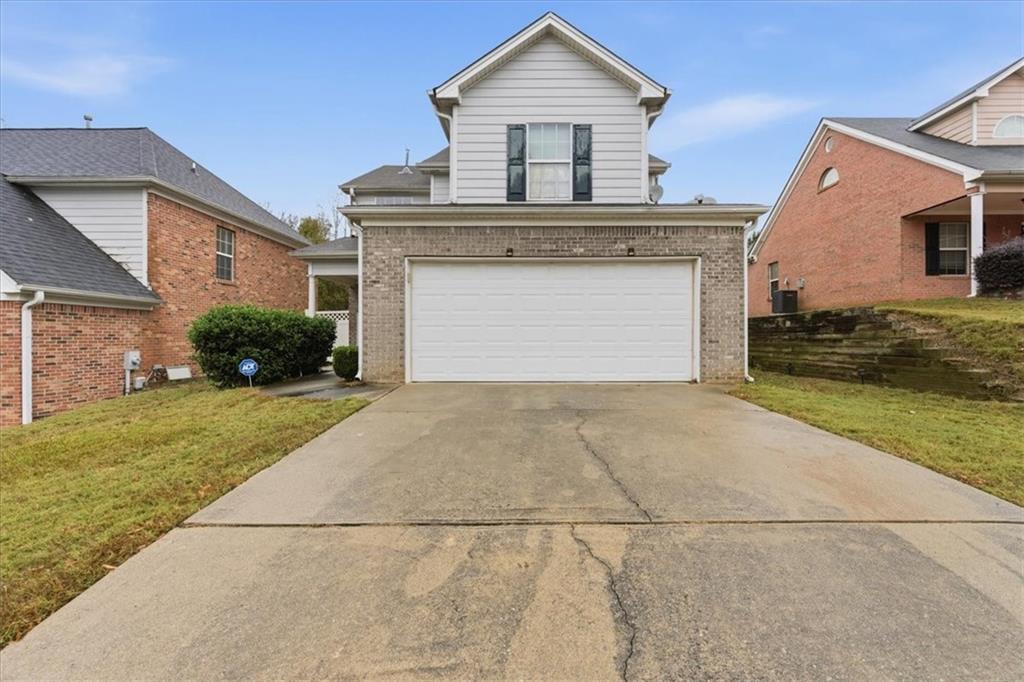 809 Winsap Drive Stockbridge, GA 30281 - Photo 2 of 41 a front view of a house with a yard and garage